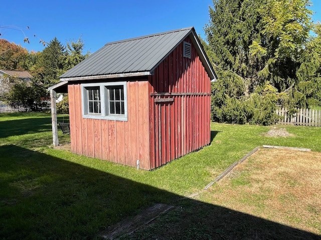 view of outbuilding featuring a lawn