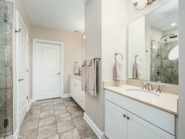 bathroom featuring a shower with shower door and vanity