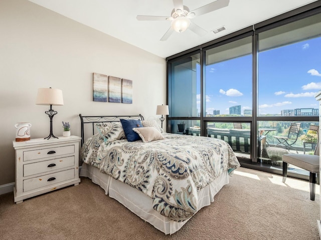 bedroom featuring floor to ceiling windows, carpet floors, and ceiling fan