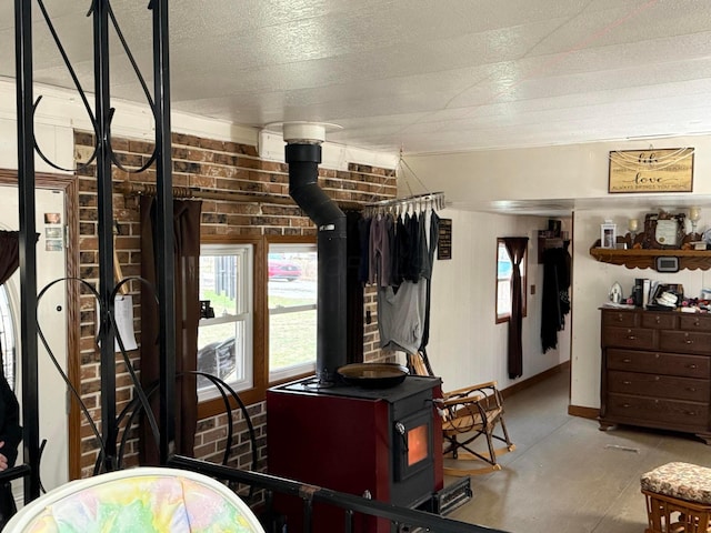 bedroom featuring a wood stove and brick wall