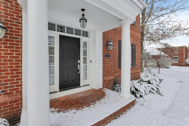 view of snow covered property entrance