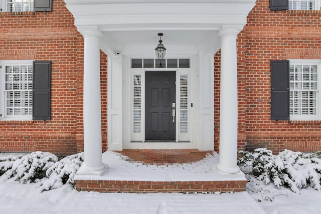 view of snow covered property entrance