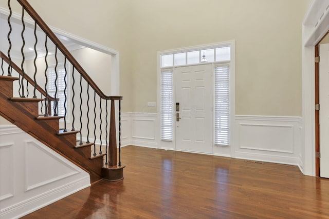 foyer entrance featuring dark wood-type flooring