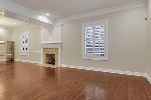 unfurnished living room with a chandelier, crown molding, a high end fireplace, and wood-type flooring