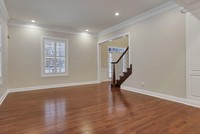 spare room with dark hardwood / wood-style floors and crown molding