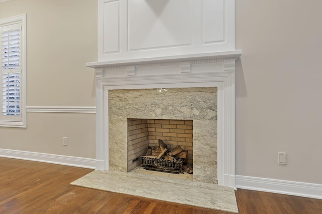 room details featuring a fireplace and wood-type flooring