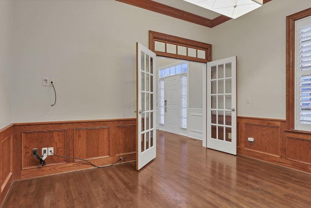 interior space featuring dark hardwood / wood-style flooring, french doors, and ornamental molding