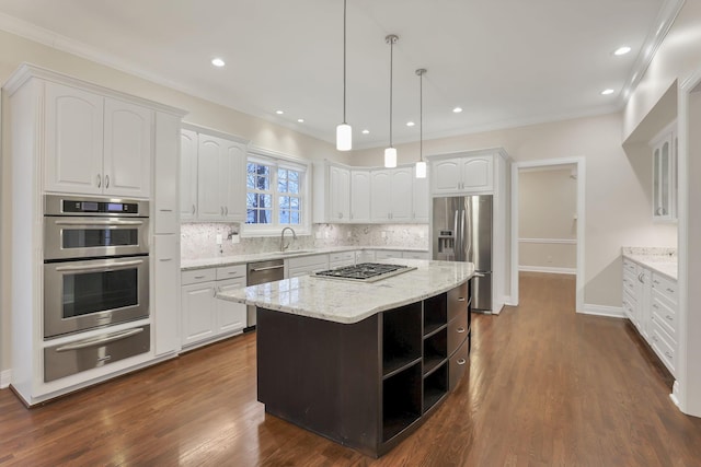 kitchen featuring hanging light fixtures, light stone countertops, a kitchen island, white cabinetry, and stainless steel appliances