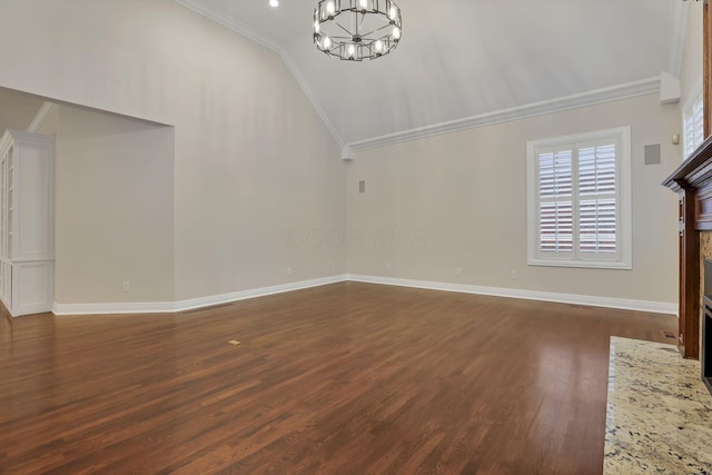 unfurnished living room featuring lofted ceiling, dark wood-type flooring, an inviting chandelier, and crown molding