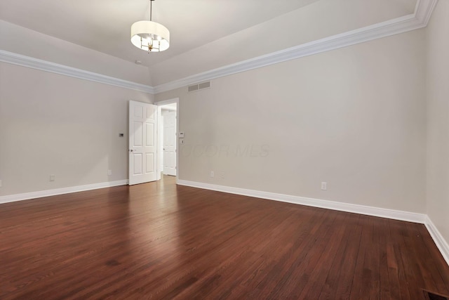 spare room featuring dark wood-type flooring, lofted ceiling, and ornamental molding