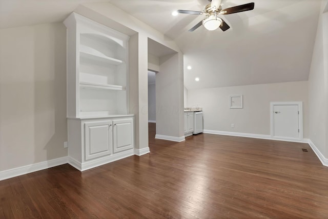 bonus room featuring ceiling fan, built in features, dark wood-type flooring, and vaulted ceiling