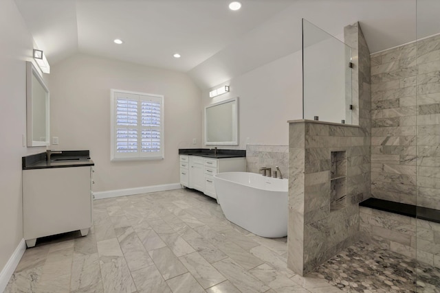 bathroom with separate shower and tub, vanity, and vaulted ceiling