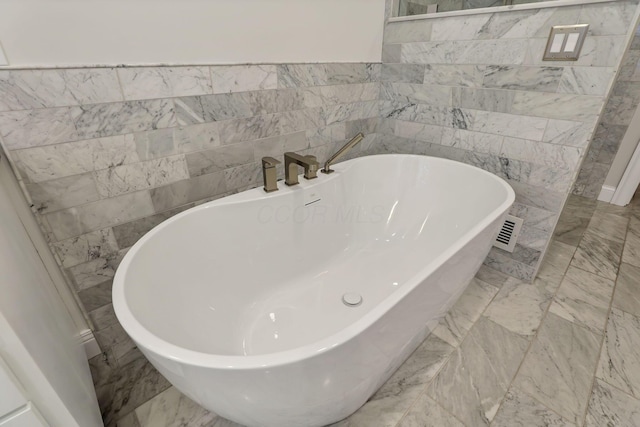 bathroom with a tub to relax in