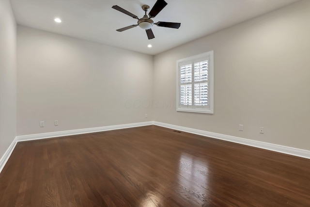 spare room with dark hardwood / wood-style floors and ceiling fan