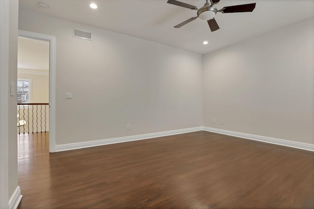 unfurnished room with ceiling fan and dark wood-type flooring