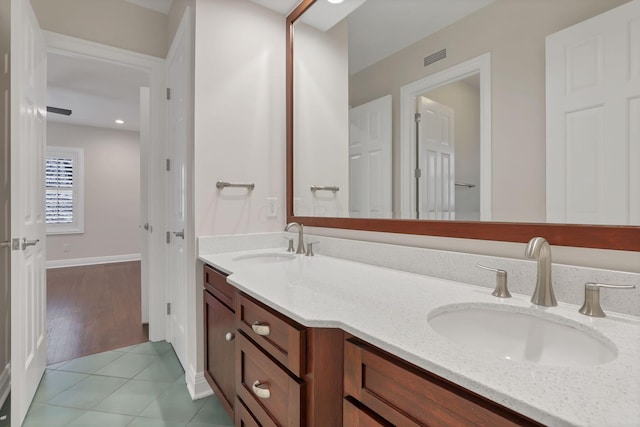 bathroom with tile patterned flooring and vanity