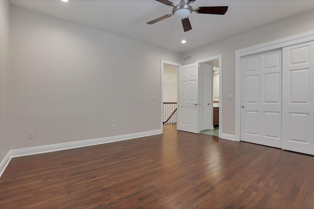 unfurnished bedroom featuring dark hardwood / wood-style flooring, a closet, and ceiling fan