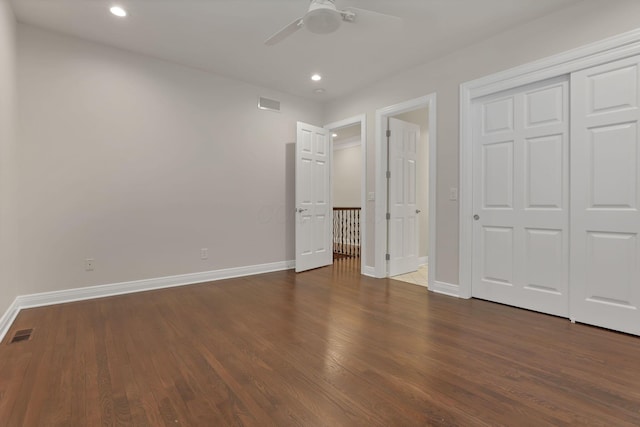 unfurnished bedroom with ceiling fan, a closet, and dark hardwood / wood-style floors