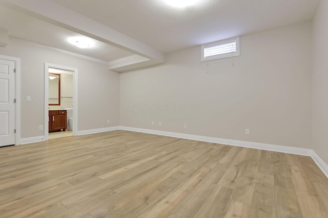 basement with light hardwood / wood-style floors