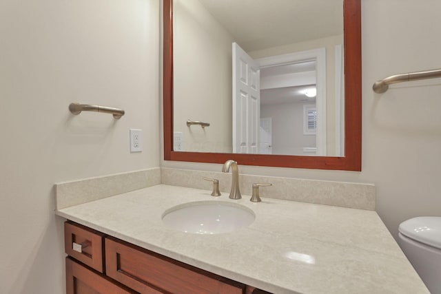 bathroom featuring vanity and toilet