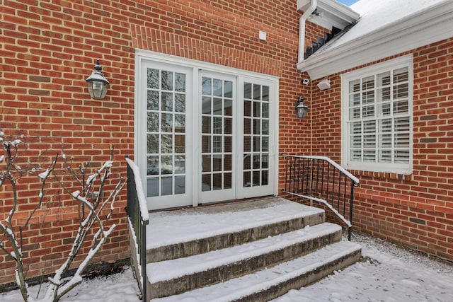 view of snow covered property entrance