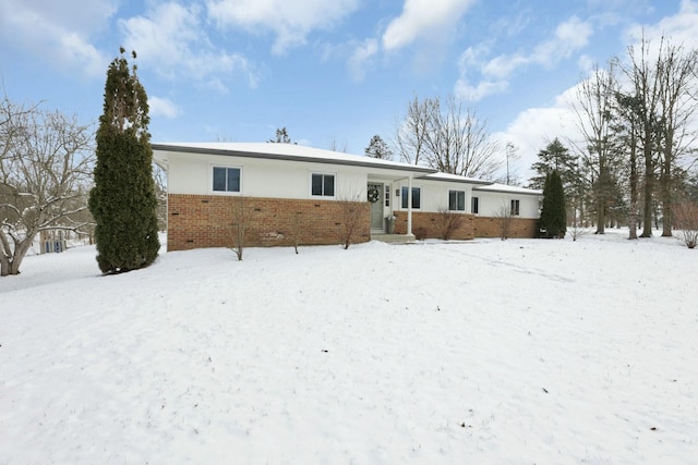 view of snow covered back of property