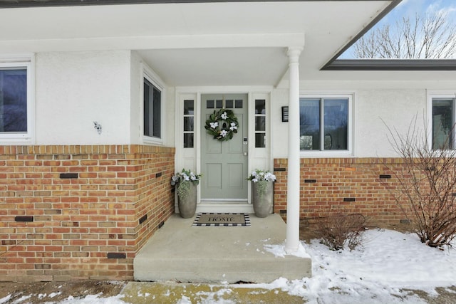 view of snow covered property entrance