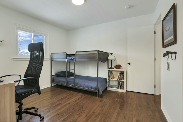 bedroom with dark hardwood / wood-style floors