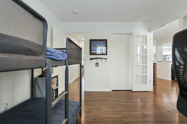 bedroom with a closet and dark hardwood / wood-style flooring