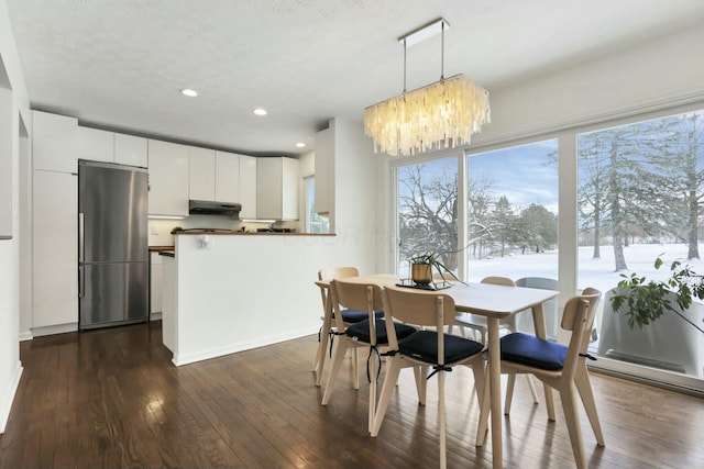 dining area with a notable chandelier and dark wood-type flooring