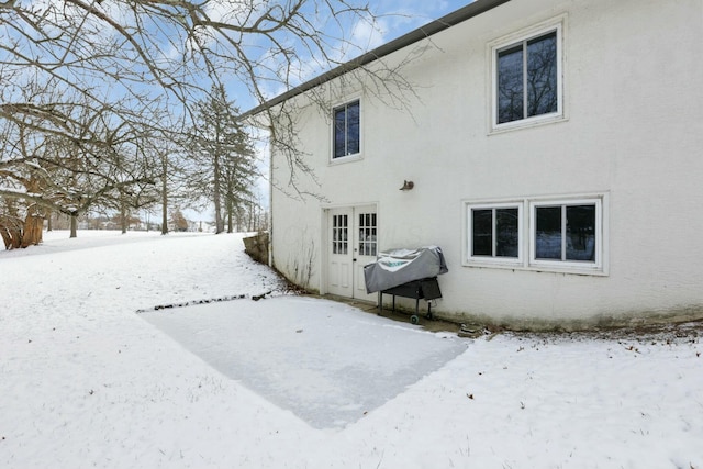 view of snow covered rear of property