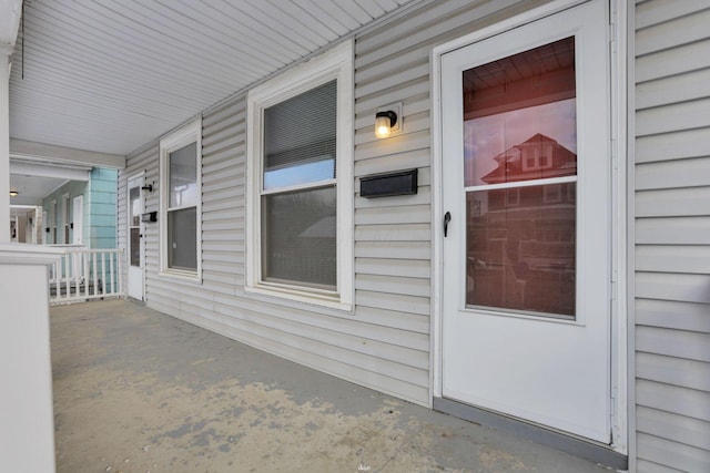 view of exterior entry featuring a porch