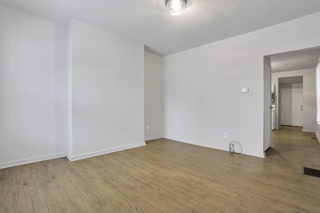 unfurnished room featuring hardwood / wood-style floors