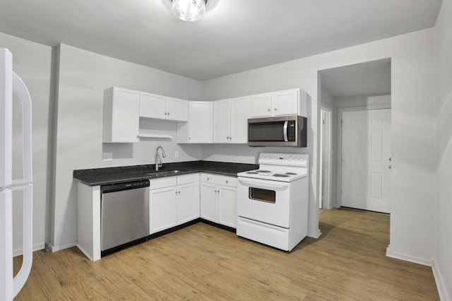 kitchen featuring white cabinets, light hardwood / wood-style floors, sink, and stainless steel appliances