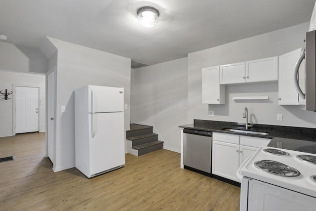 kitchen with white cabinetry, sink, white appliances, and light wood-type flooring