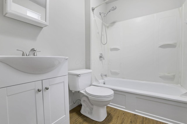 full bathroom with hardwood / wood-style flooring, vanity, toilet, and shower / bath combination