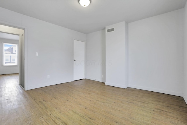 unfurnished room with light hardwood / wood-style floors