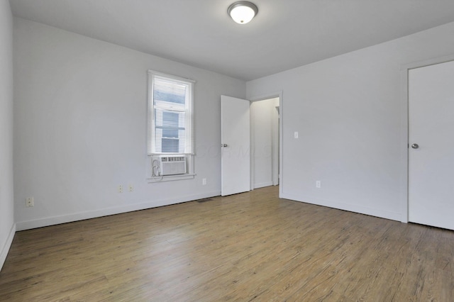 spare room with light hardwood / wood-style flooring and cooling unit