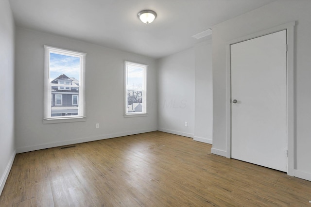 empty room with hardwood / wood-style floors