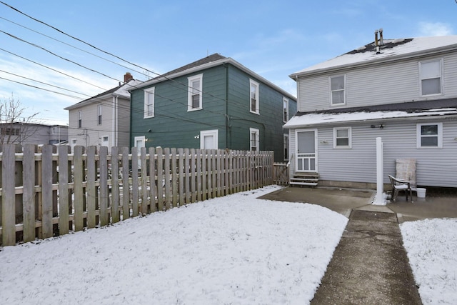 view of snow covered rear of property