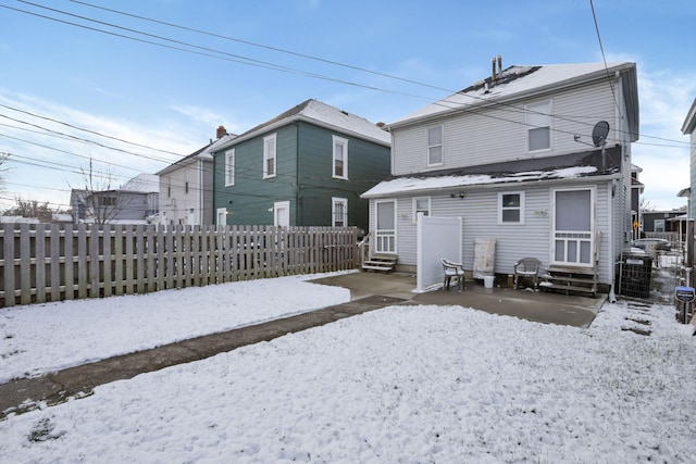 view of snow covered rear of property