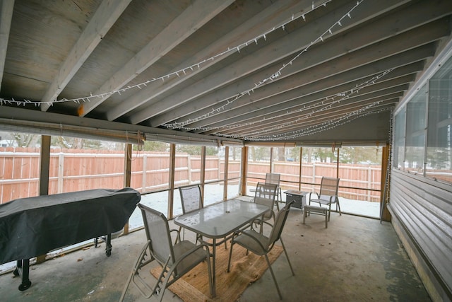 unfurnished sunroom with vaulted ceiling