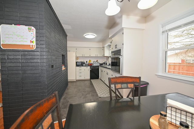 kitchen featuring black appliances and white cabinets