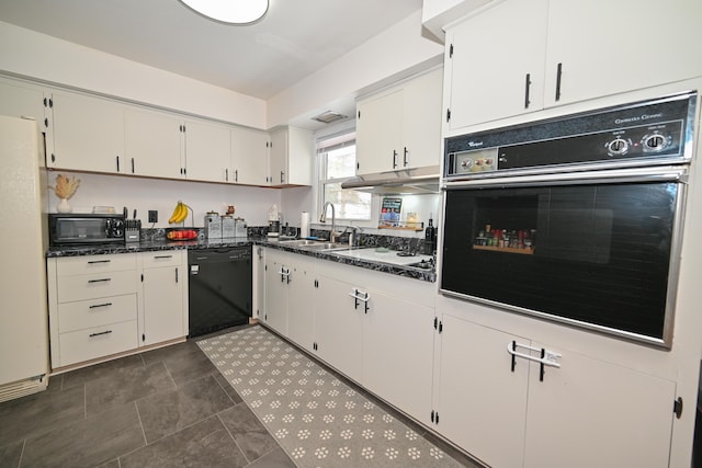 kitchen featuring white cabinets, sink, dark stone counters, and black appliances