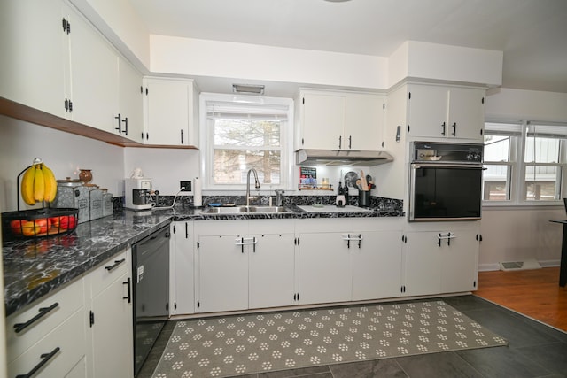 kitchen featuring sink, white cabinetry, dark stone countertops, and black appliances