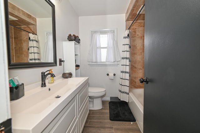 full bathroom featuring shower / bath combo, vanity, and toilet