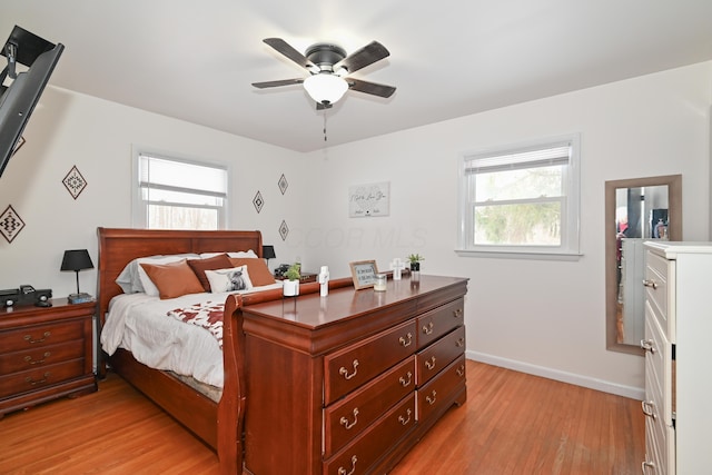 bedroom with light hardwood / wood-style floors and ceiling fan