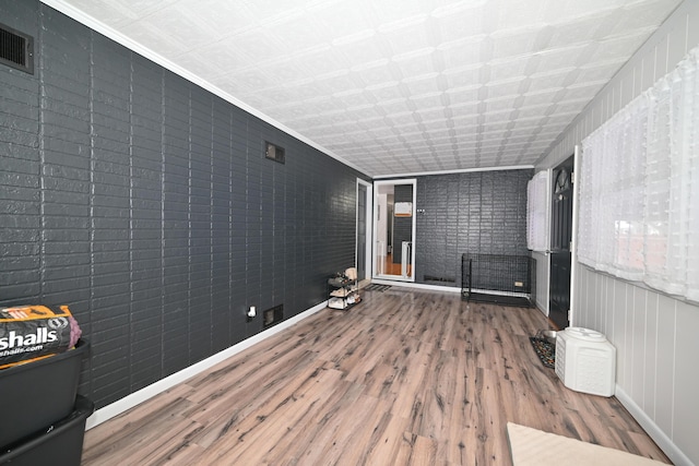 interior space featuring hardwood / wood-style floors and ornamental molding