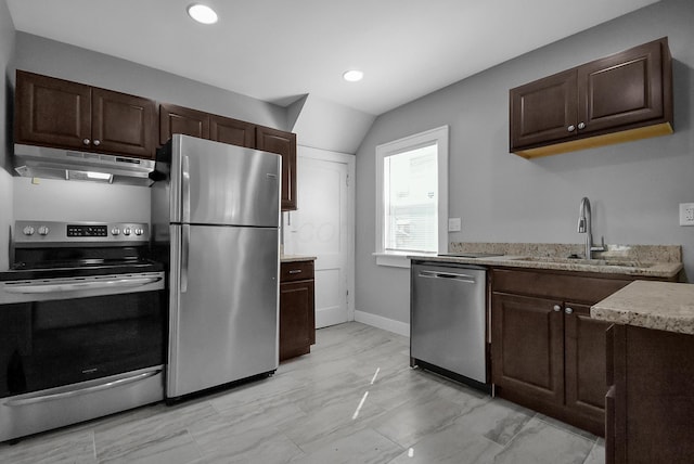 kitchen with light stone countertops, dark brown cabinetry, stainless steel appliances, and sink