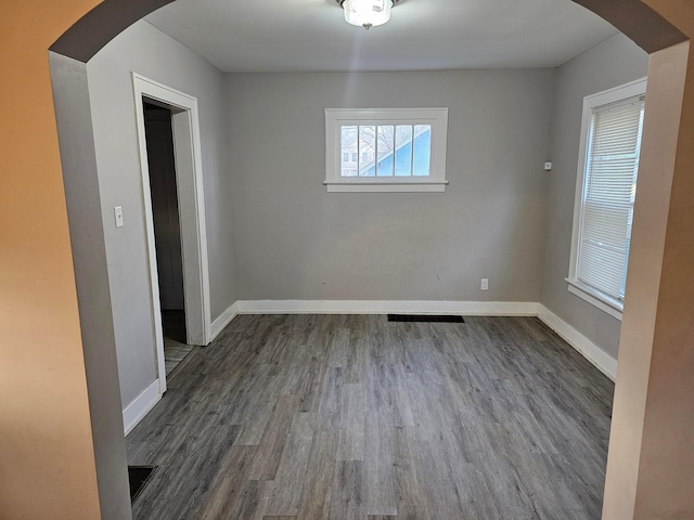 unfurnished room with dark hardwood / wood-style floors